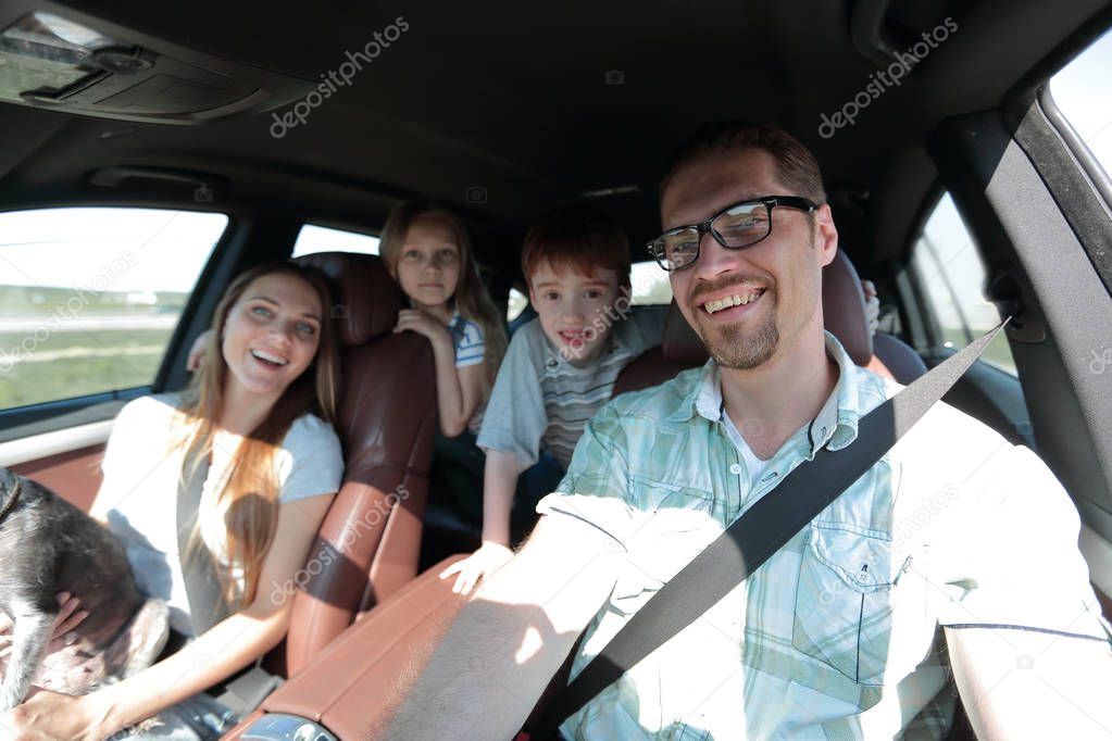 close-knit family with two children traveling in the car.