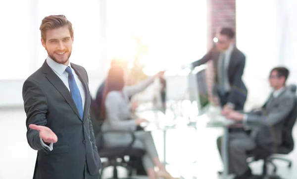 Businessman with hand in a welcoming gesture at the office — Stock Photo, Image