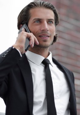 İş adamı akıllı telefondan konuşuyor..