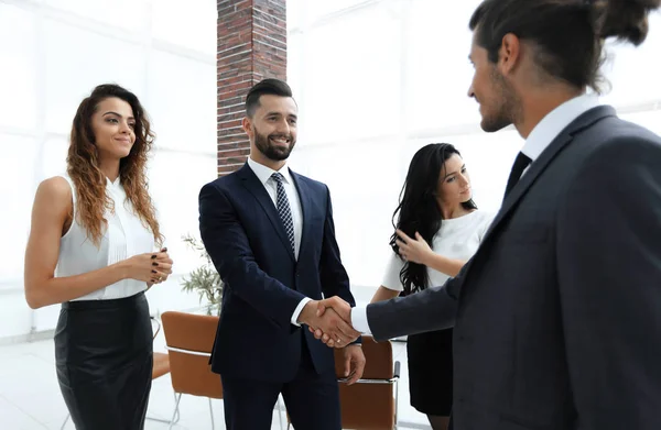 Handshake of business people on the background of the office — Stock Photo, Image