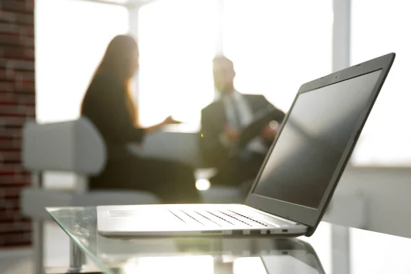 Focus on laptop on the table. Blurred people on background. — Stock Photo, Image