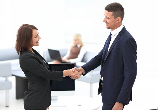 handshake business partners at the negotiating table.