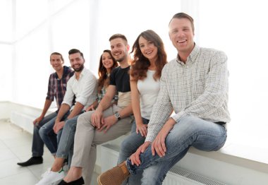 bekleme odasında sandalyelere oturan genç yaratıcı insanlar