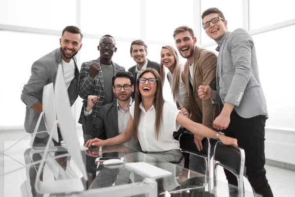 Celebrating business team near the desktop — Stock Photo, Image