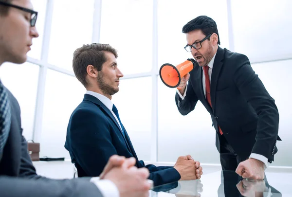 Businessman with a megaphone in the conference room during the meeting — Stock Photo, Image