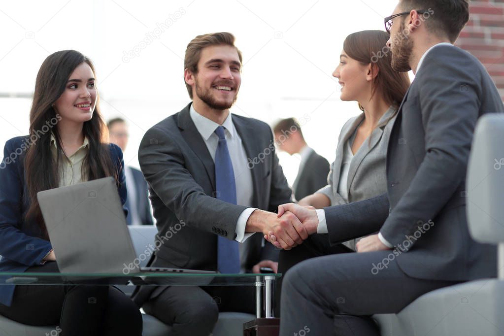 Two colleagues handshaking after meeting.