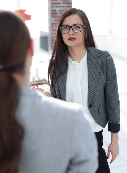 business woman talking to an office worker