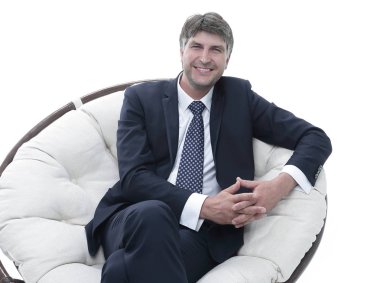 Başarılı bir iş adamı yumuşak bir rahat sandalyede oturur.