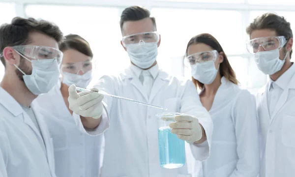 Closeup of a group of medical workers working with liquids — Stock Photo, Image