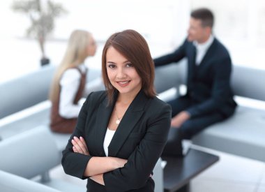 successful young business woman on blurred background office clipart