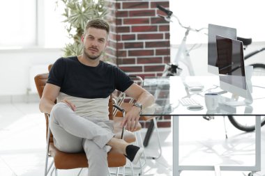 onun işyerinde oturan kendine güvenen genç adam