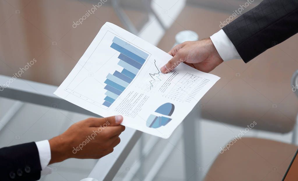 Business people discussing financial graphs