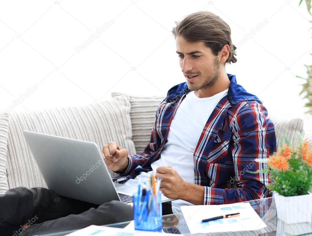 surprised young man working with laptop from home.