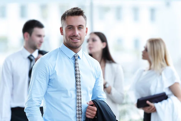 Businessman standing in the center of the modern office — Stock Photo, Image