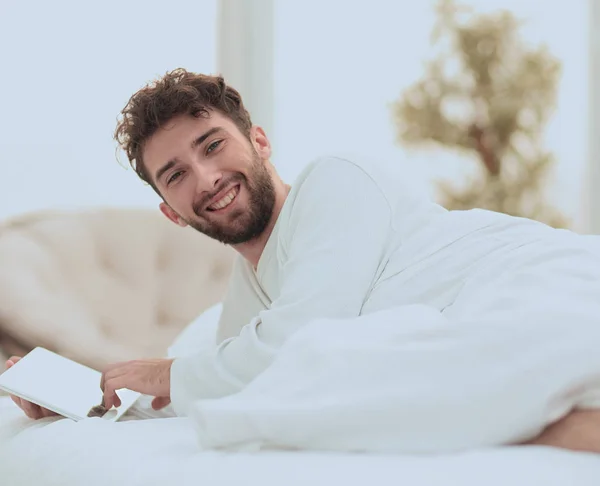 Closeup.awakened man typing with a digital tablet — Stock Photo, Image