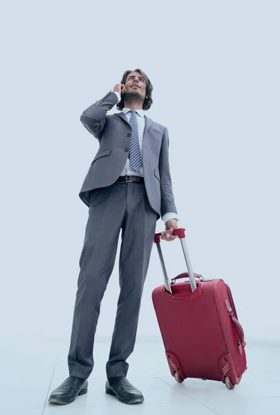 Bottom view.businessman con bagagli parlare su un cellulare — Foto Stock