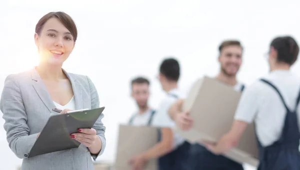 Managerin hält Klemmbrett mit Mover auf verschwommenem Hintergrund — Stockfoto