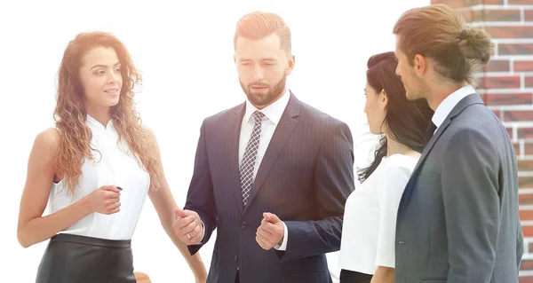 Team di lavoro sorridente parlando, in piedi in ufficio — Foto Stock