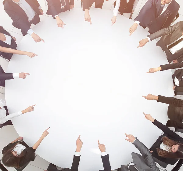 Closeup .business team pointing in the center of the table. — Stock Photo, Image