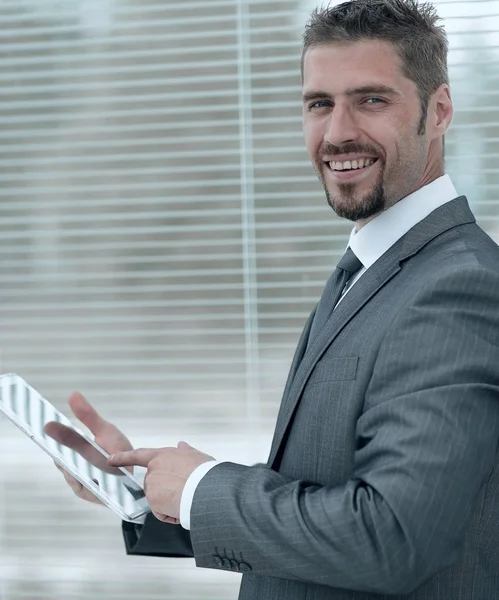 Closeup.businessman s tablet počítač stojící u okna. — Stock fotografie
