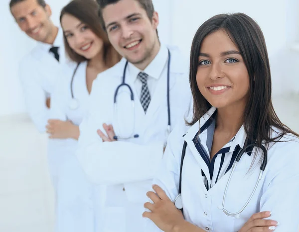 Female doctor with group of happy successful colleagues — Stock Photo, Image