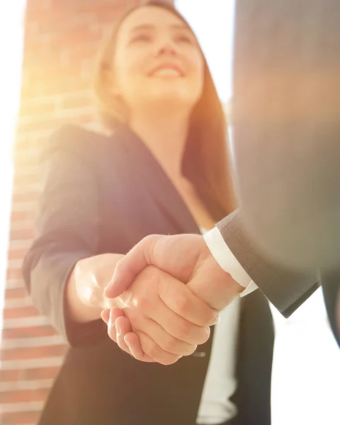 Close up of businessman and businesswoman shaking hands