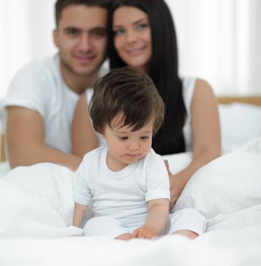 mutlu çift ve yatakta oturmuş oğul