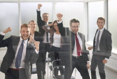 Muzaffer iş ekibi konferans odasında duruyor.