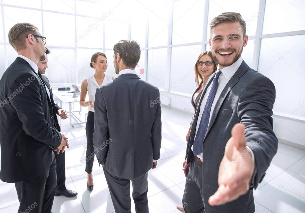 smiling businessman gives hand for handshake