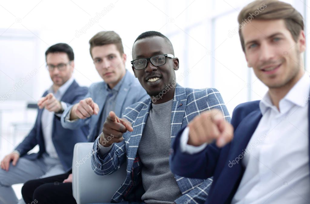 group of successful young men pointing their fingers at you