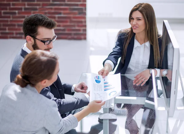 assistant passes business woman working document