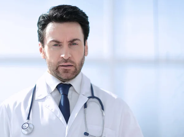 Portrait of serious doctor on blurred background — Stock Photo, Image