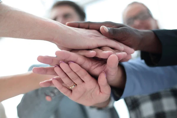 Top view of young people putting hands together — Stock Photo, Image