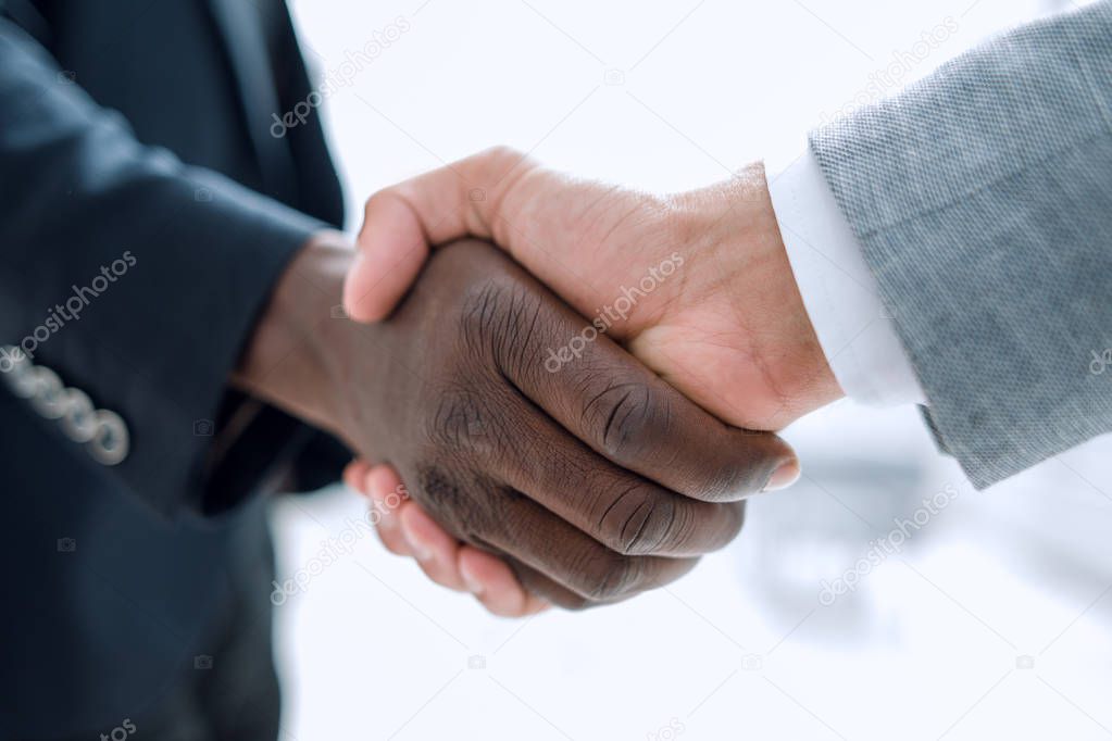 Business handshake in lofty office