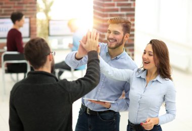 Ofiste tablet kullanan mutlu iş ekibi.