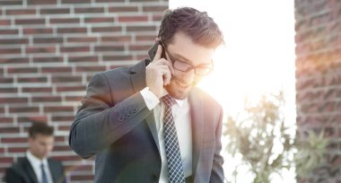 ofisinde smartphone cep telefonu ile konuşurken işadamı