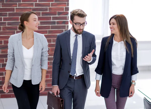 boss and employees walk around the office