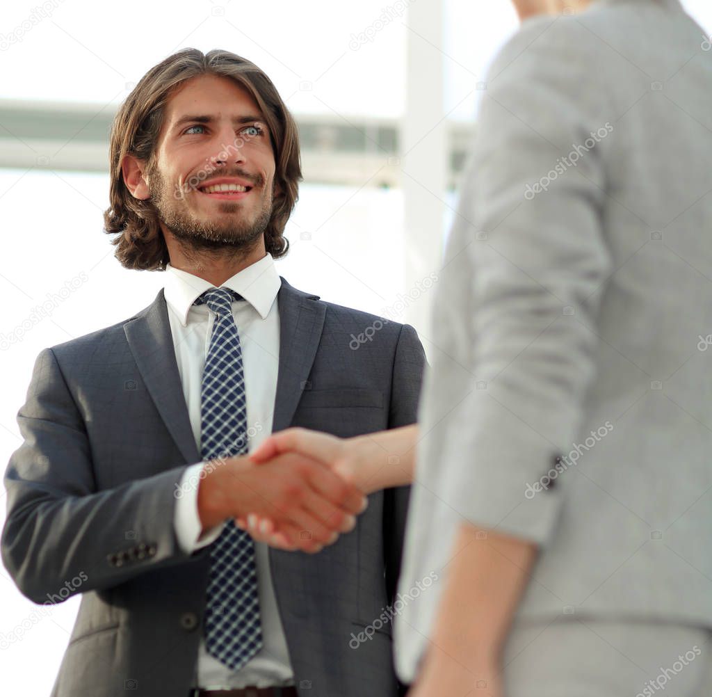 Friendly smiling business people  handshaking after pleasant tal