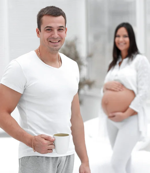 Closeup of husband and pregnant wife ,standing in the new living room — Stock Photo, Image