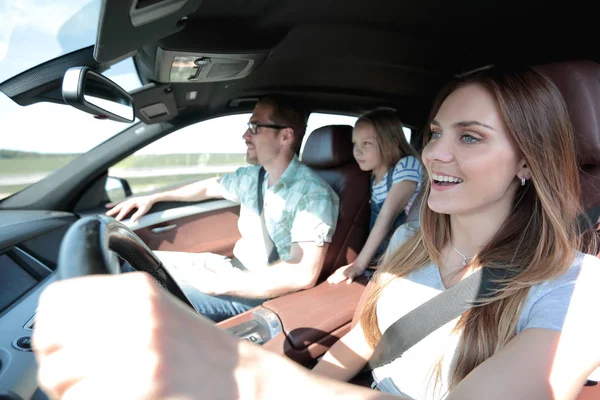 happy mom driving a family car