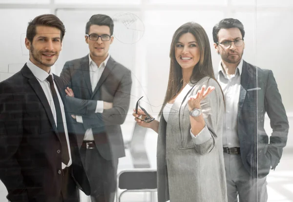 Group of business people standing in a modern office — Stock Photo, Image