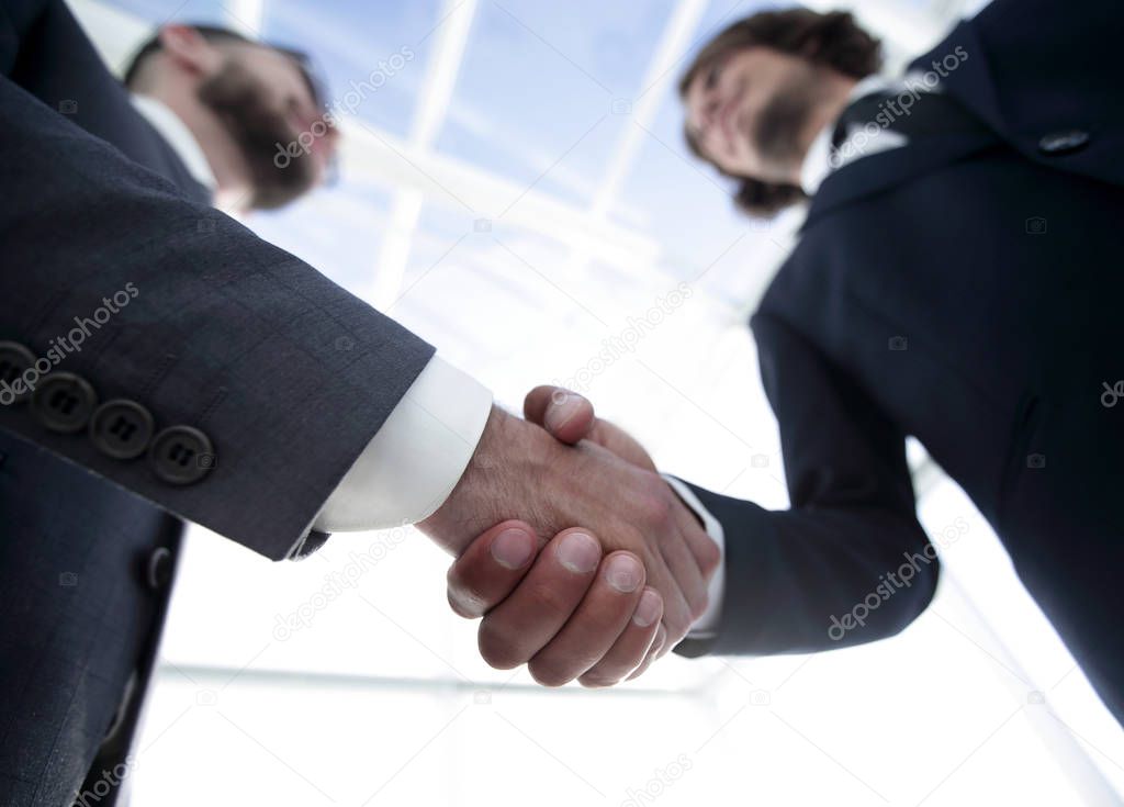 Photo of handshake of two happy businessmen