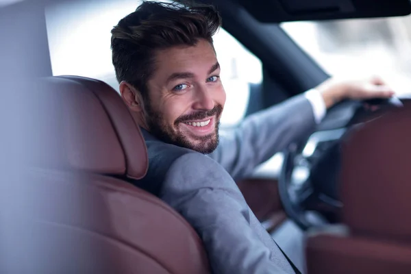 Successful man sitting behind the wheel of a prestigious car — Stock Photo, Image