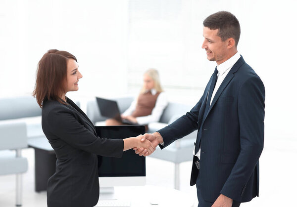 handshake business partners at the negotiating table.