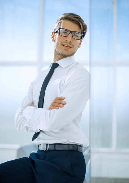 Businessman standing in bright office — Stock Photo, Image