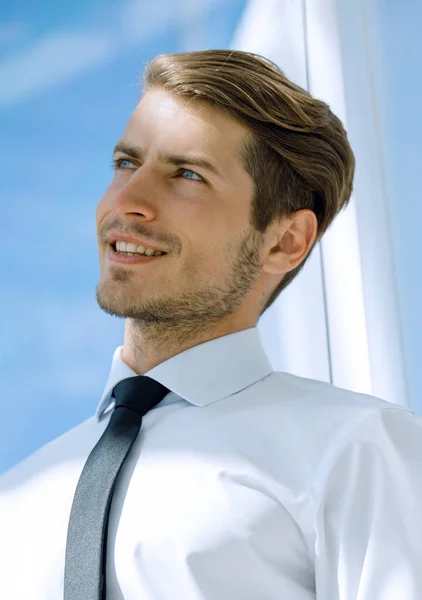 Close up.successful businessman standing near the office window — Stock Photo, Image