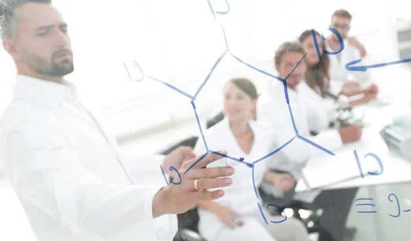 From behind the glass. a scientist standing near the blackboard in the lab. — Stock Photo, Image