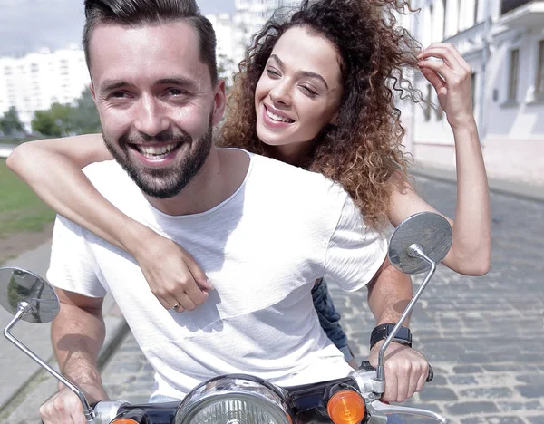 Happy cheerful couple riding vintage scooter outdoors. — Stock Photo, Image