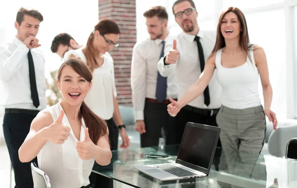 Smiling business team showing thumbs up — Stock Photo, Image