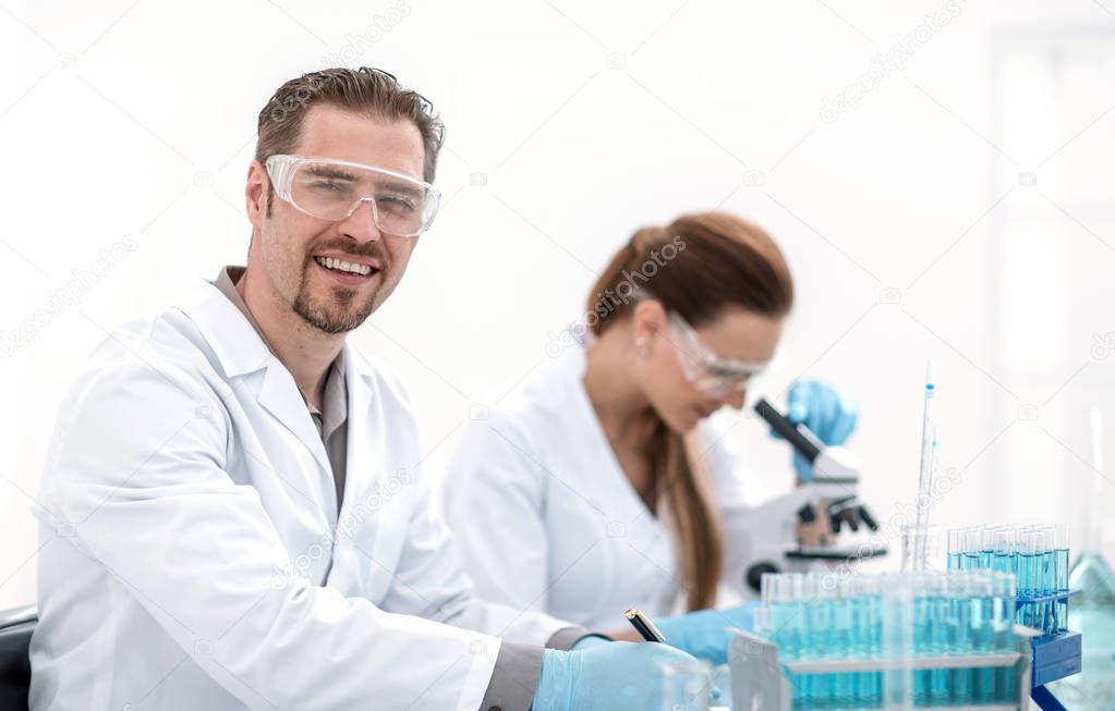 two scientists biologists sitting at the laboratory table